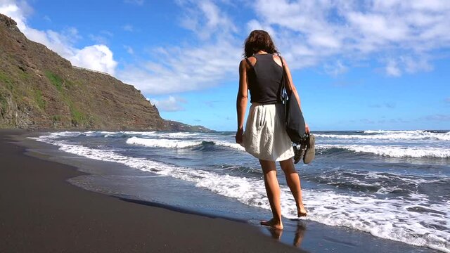 A young tourist enjoying on the beach of Nogales in the east of the island of La Palma, Canary Islands. Spain
