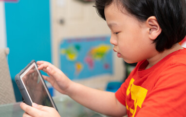 asian boy use tablet online learn from home