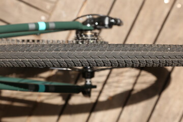 A gravel tire wheel on a city commuter bicycle. This photo has selective focus. 