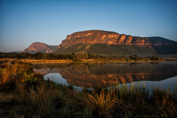 Landscape at sunrise with mountains and a lake which gives a nice reflection in Entabeni Game Reserve in the Waterberg Area in South Africa