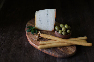 still life with bread sticks and mint cheese and olives