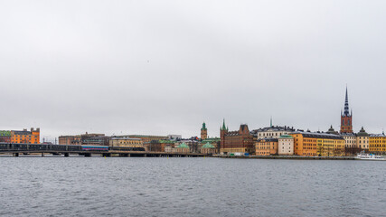 Naklejka premium A panoramic view on shoreline in Stockholm from Fjallgatan view point on a cloudy winter day