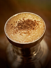 close up of a glass of cappuccino coffee