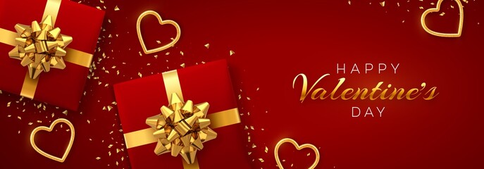 Fototapeta na wymiar Happy Valentine's Day banner template. Realistic gift boxes with golden bow, and shining red and gold hearts with glitter texture and confetti on red background. Top view. Vector illustration.