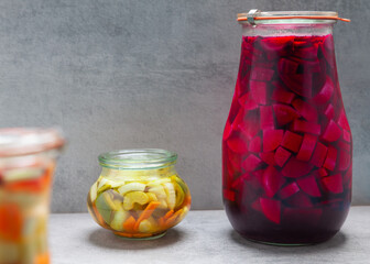 Two closed glass jars of with various vegetables pickled. Home food preservation stock for winter.