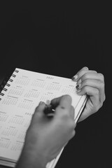 Woman holding an agenda while writing