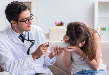 Woman with pet rabbit visiting vet doctor