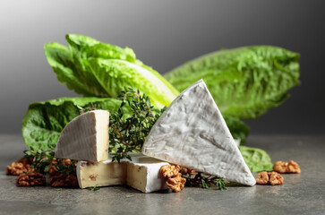 Fresh Brie cheese with lettuce, thyme, and walnuts.