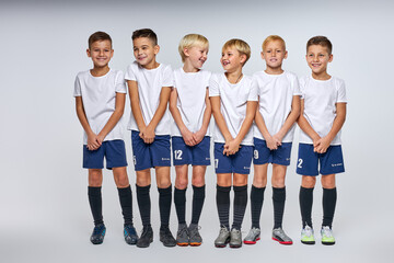 school boys in uniform stand defending the gate, boys in a row, football sport game concept