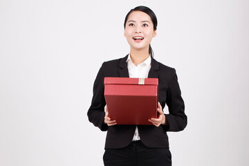 A business woman carrying a gift box 