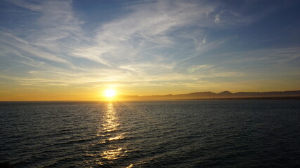 sunset over the mountains near the sea