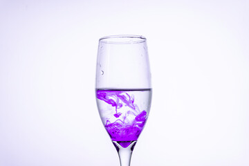 Purple ink in a glass of water