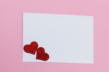 Mock-up of blank white card on light pink background with hearts, funny desktop for valentine's day
