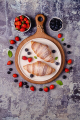 Breakfast with croissants and fresh fruits.