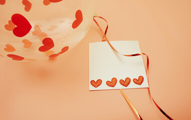 Valentine's day card. Transparent balloon with hearts and a card on a ribbon. Top view background....