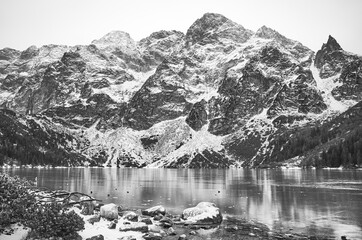 Black and white picture of frozen Morskie Oko Lake (Eye of the Sea) in Tatra National Park, Poland.