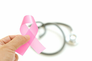 woman holding in hands pink breast cancer sign on white background and stethoscope.