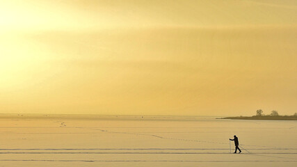 Skiing man on the ice of the lake