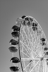 ferris wheel in black and white image. The cabin of the Ferris wheel against the sky at the top. Background image of the Ferris wheel.