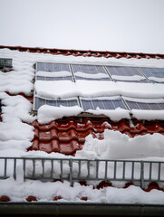 Photovoltaic covered with snow in winter. Snow slides down dangerously from the photovoltaic system. The snow protection prevents the snow from falling freely.