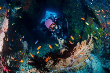 Fototapeta na wymiar Female SCUBA diver on a tropical coral reef in the Andaman Sea, Asia
