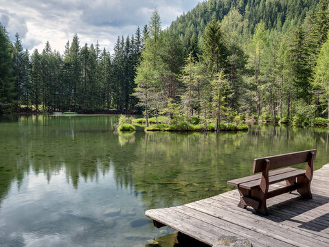 Wooden bench and nice view over Lake Winkelbergsee near L&auml;ngenfeld, Tyrol, Austria