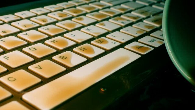 coffe spilled on a computer keyboard close-up