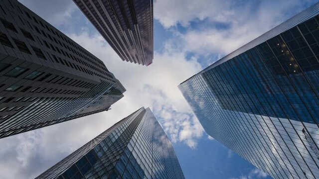 Business and finance concept, zoom out time lapse looking up at modern office building architecture in the financial district of Toronto in Ontario, Canada.