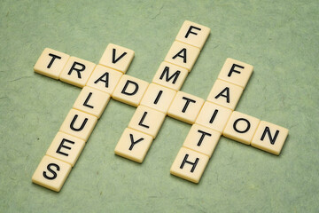 values, tradition, family and faith  crossword in ivory letter tiles against textured handmade...