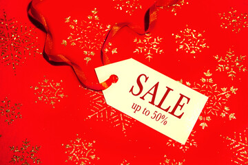 Naklejka na ściany i meble Sale - text on a label for a Christmas sale, on a red background.