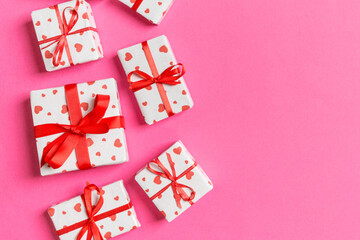 Top view of gift boxes with red hearts on colorful background. St Valentine's day concept with copy space