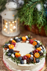 Fototapeta na wymiar Cake decorated with fruits on the christmas table