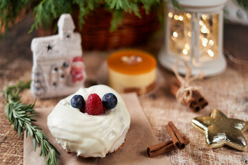 Cake decorated with blackberries and raspberries on the christmas table