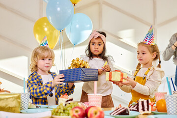 girl getting gifts for birthday by friends at home, congratulating. event, celebration, birthday party concept