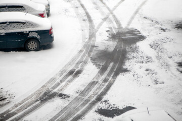 First snow. Traces of passing cars on the asphalt