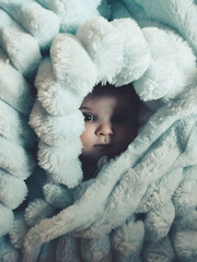 Little baby wrapped up with a warm green blanket