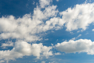 Cirrus and cumulus clouds on blue sky background.