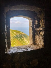 View of the Mediterranean ocean through an old stone window