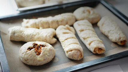 Whole wheat bread from homemade whole grain dough made by woman with red apron. Healthy pastry with many grains.