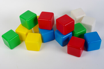 Obraz premium Colored plastic cubes for children's play on a light.