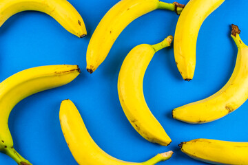 macro photo of yellow bananas over blue background © Krzysztof Bubel