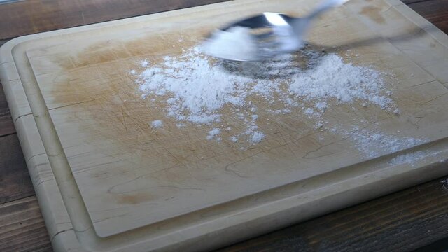 Adding fresh dough to wooden board