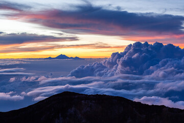 Amazing cloudscape with Mt. Rinjani at the horizon. View from Mt. Agung at sunrise. Bali, Indonesia.
