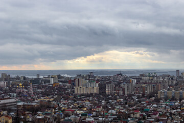 Panoramic view of the big city of Russia. A view of the city in cloudy weather with one clearing through which the sun's rays beat.
