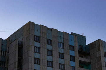 Part of the building built in the Soviet Union against the sky at sunset.