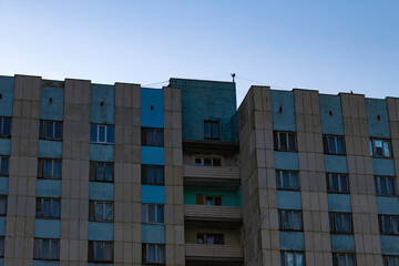 Fototapeta premium Part of the building built in the Soviet Union against the sky at sunset.