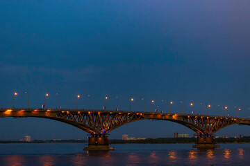 Naklejka na ściany i meble Bridge over the Volga river in the city of Saratov at night.