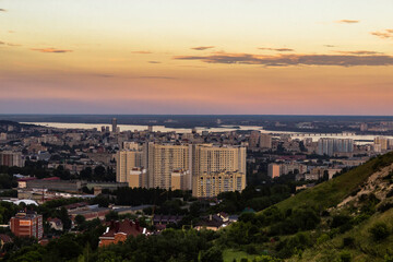 Fototapeta premium View on the high-rise residential building and the rest of the city from the hollow between the mountains. Shallow focus.