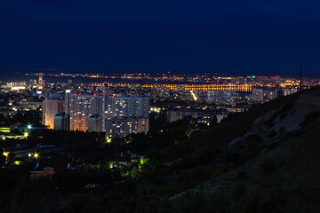 Fototapeta premium View of the city with high-rise buildings against the background of the river at night.