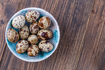 Quail eggs on the wooden plate. Quail eggs can be consumed by frying or boiling. In Indonesia quail eggs called telur puyuh.